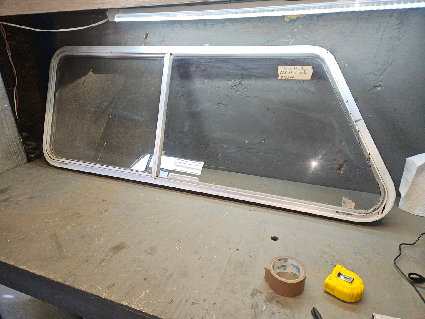 Poor condition silver angle sliding window