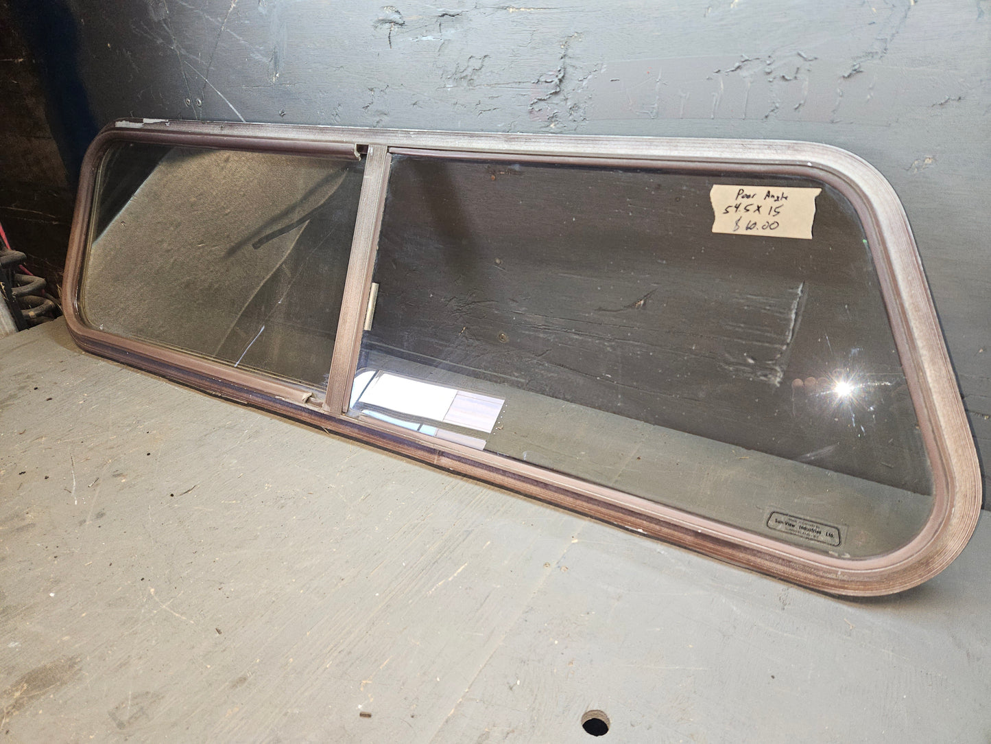Poor condition brown sliding angle cut window