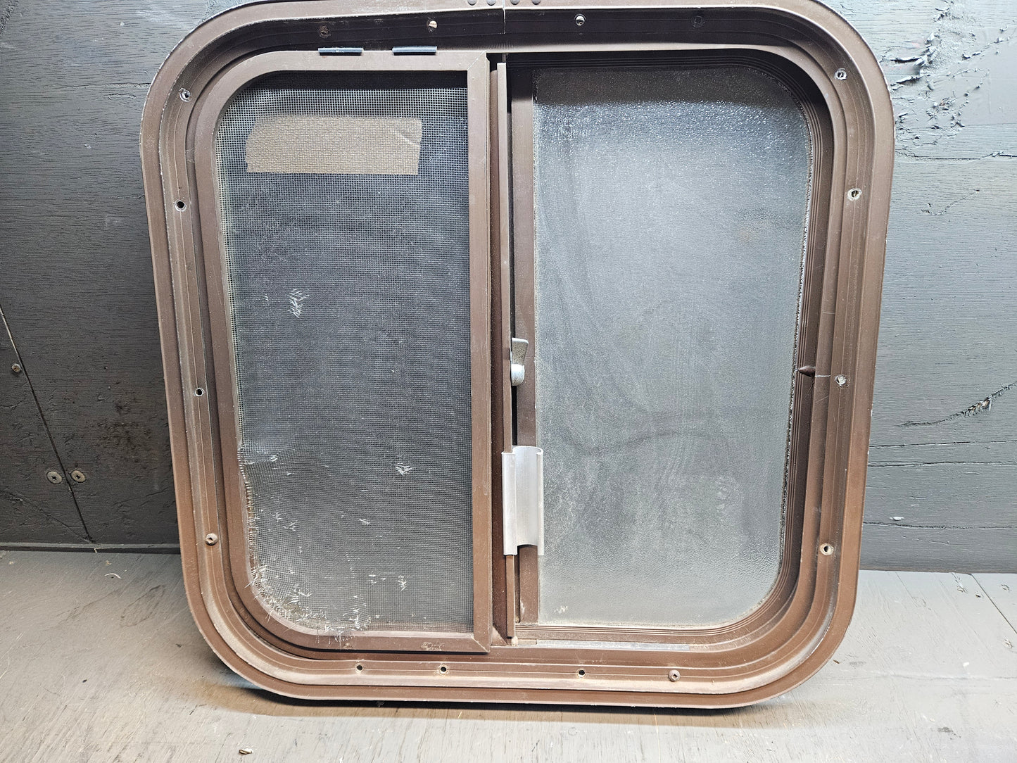 Poor condition brown slid window