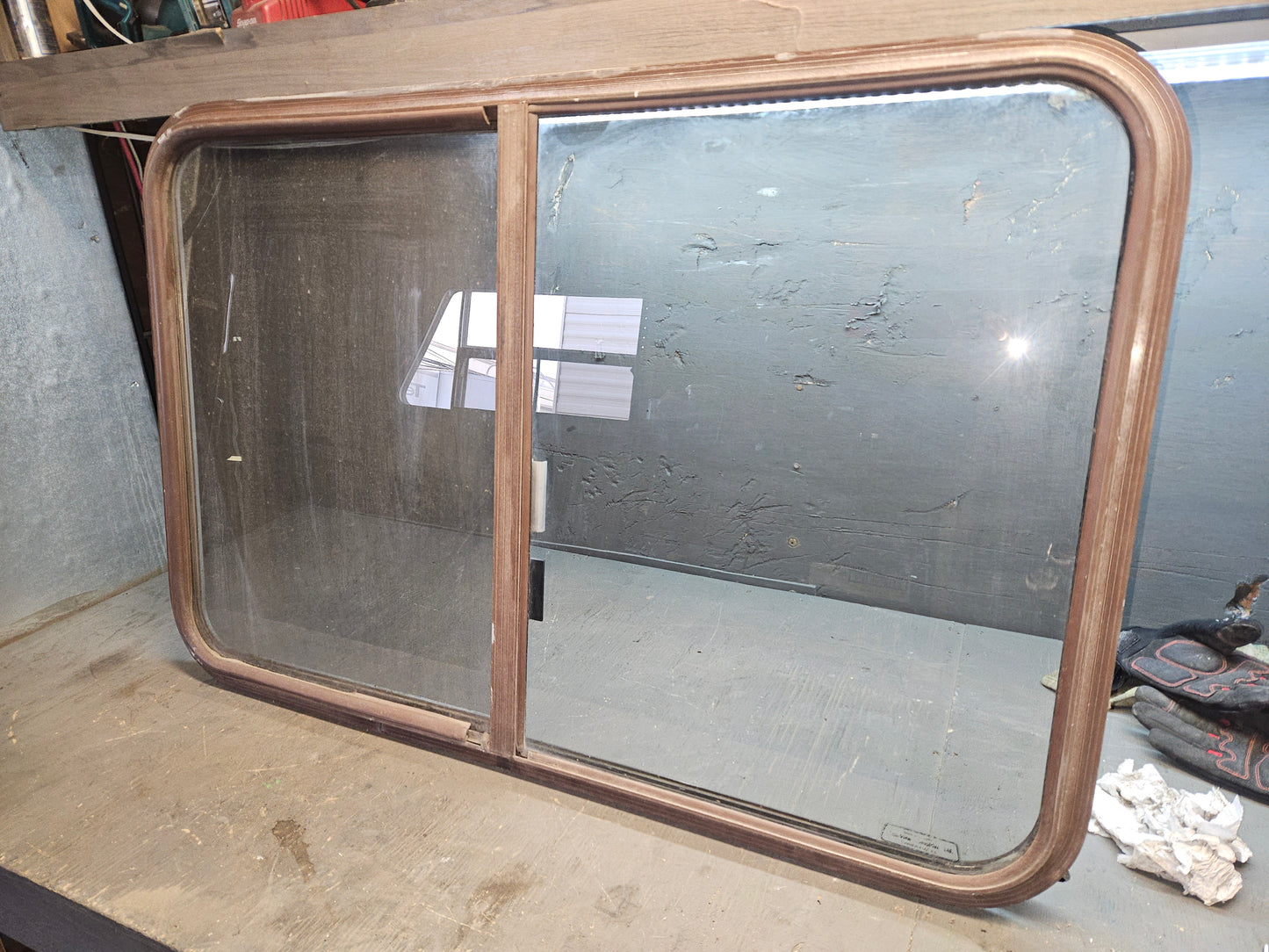 Poor condition brown slid window