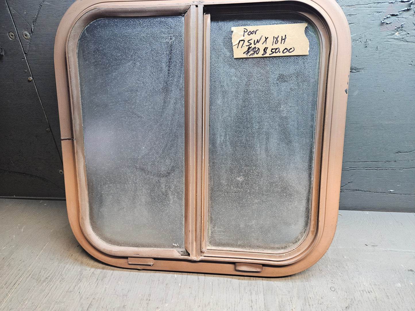 Poor condition brown slid window