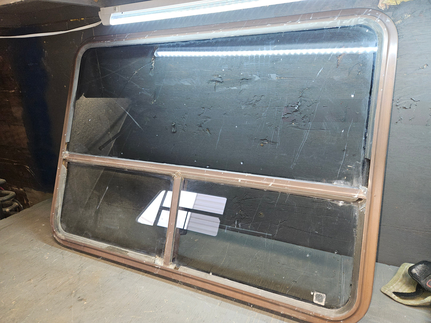 Poor condition brown slid window