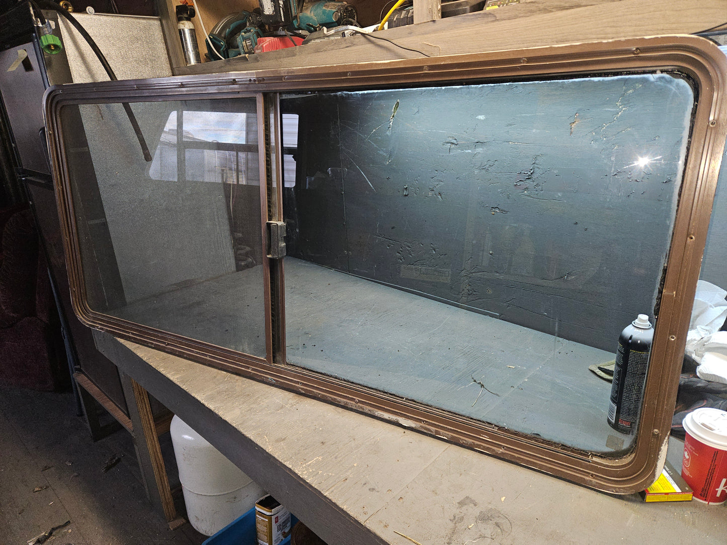 Poor condition brown slid window