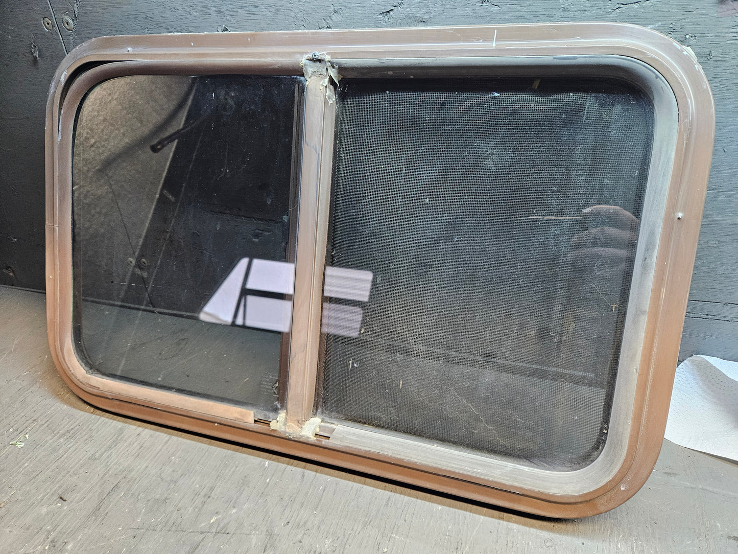 Poor condition slid window brown