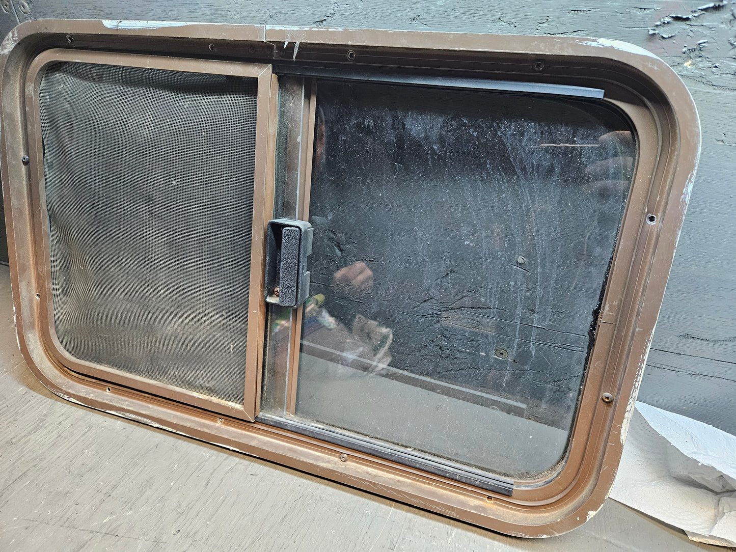 Poor condition slid window brown