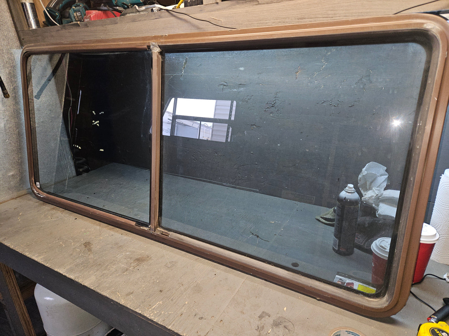 Poor condition brown slid window