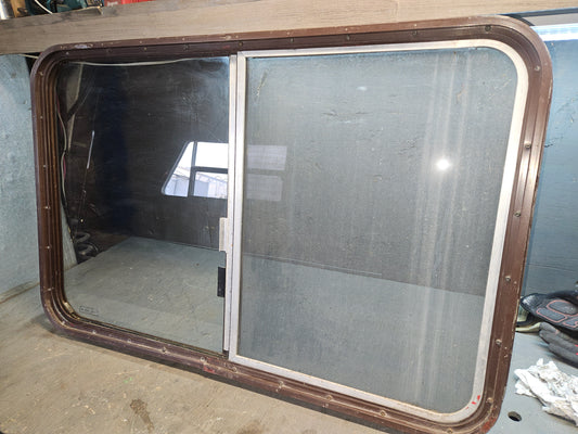 Poor condition brown slid window