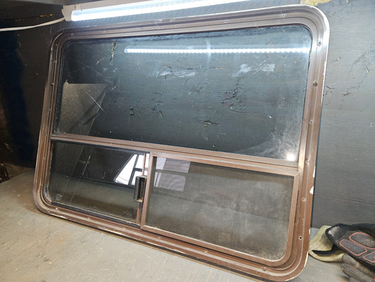 Poor condition brown slid window